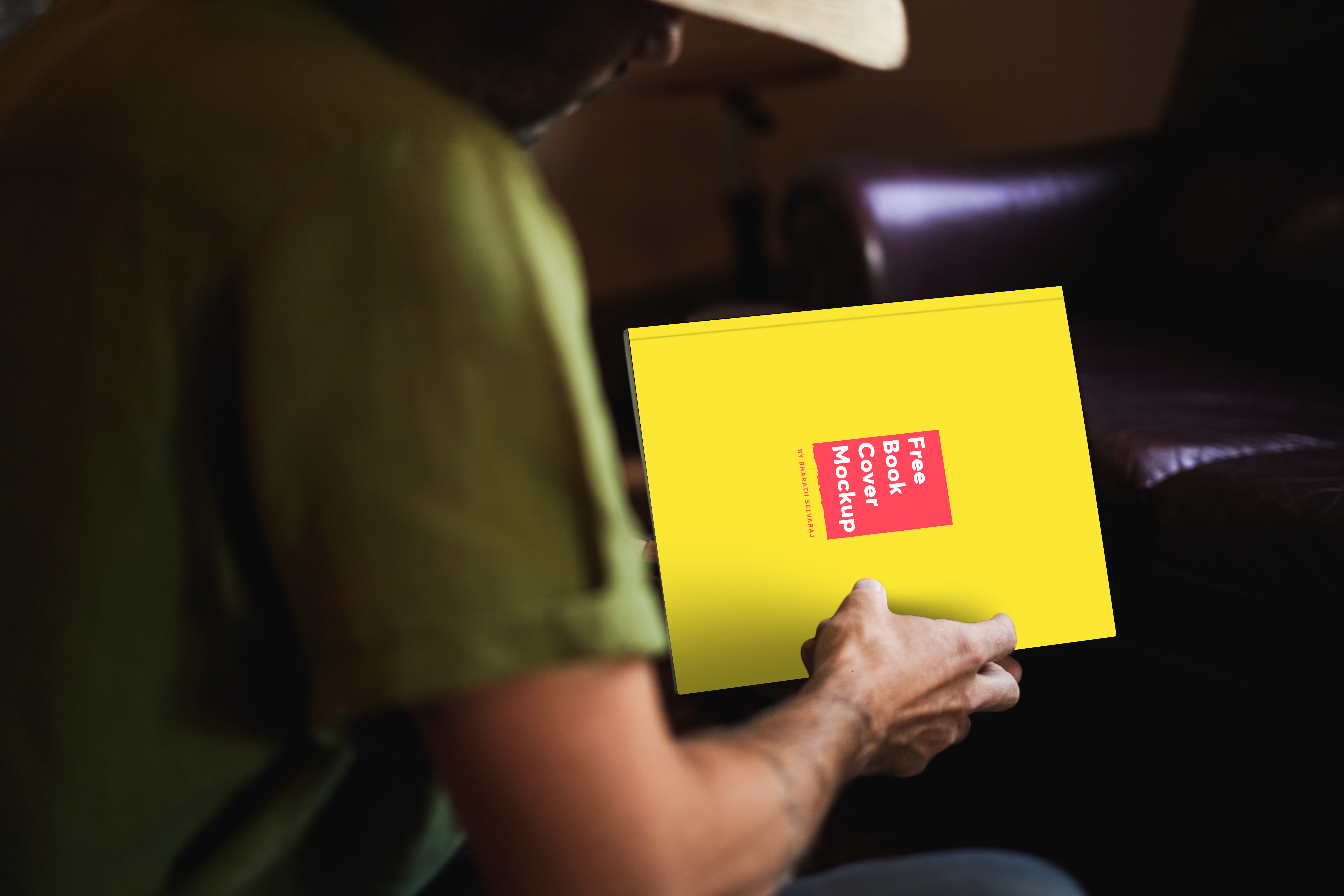 free-book-in-a-country-mans-hand-mockup
